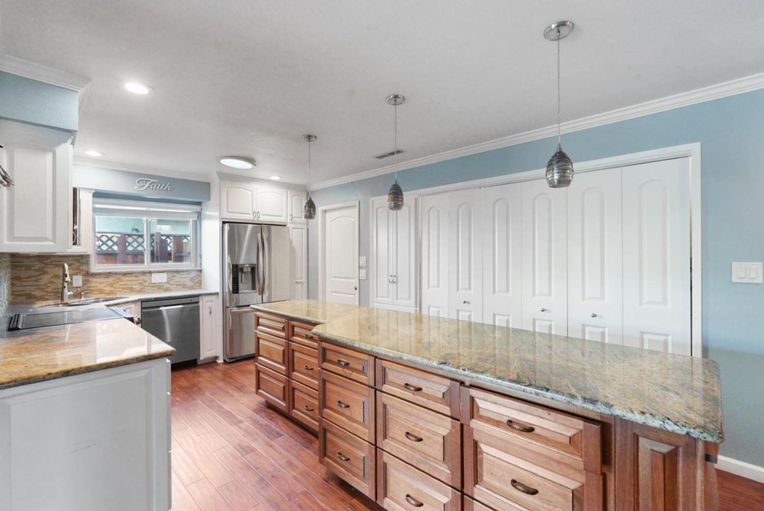 728 R Street Newman, CA 95360 - Photo 2 of 14 a kitchen with granite countertop a sink stove and refrigerator