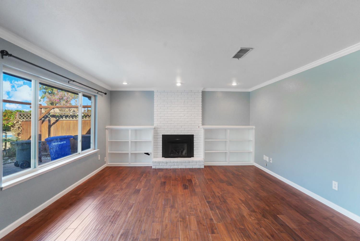 728 R Street Newman, CA 95360 - Photo 8 of 14 wooden floor in an empty room with a window