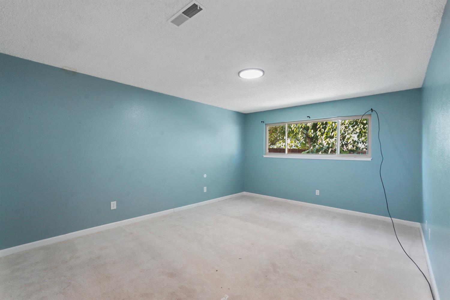 728 R Street Newman, CA 95360 - Photo 10 of 14 a view of an empty room with a window