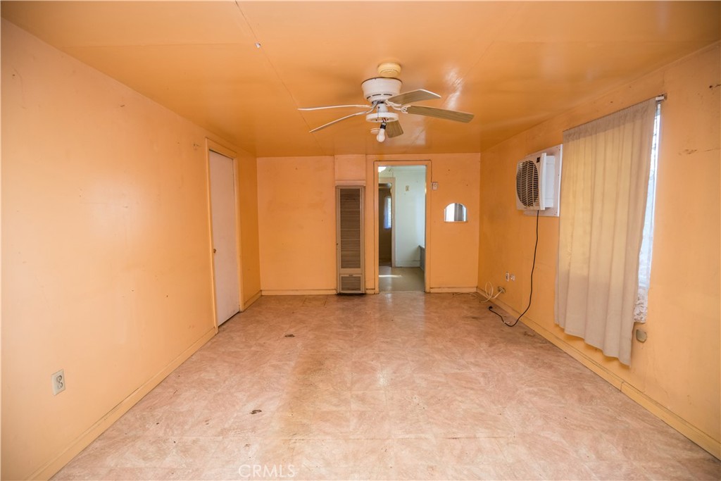 1122 N Street Merced, CA 95341 - Photo 10 of 33 an empty room with chandelier fan and windows