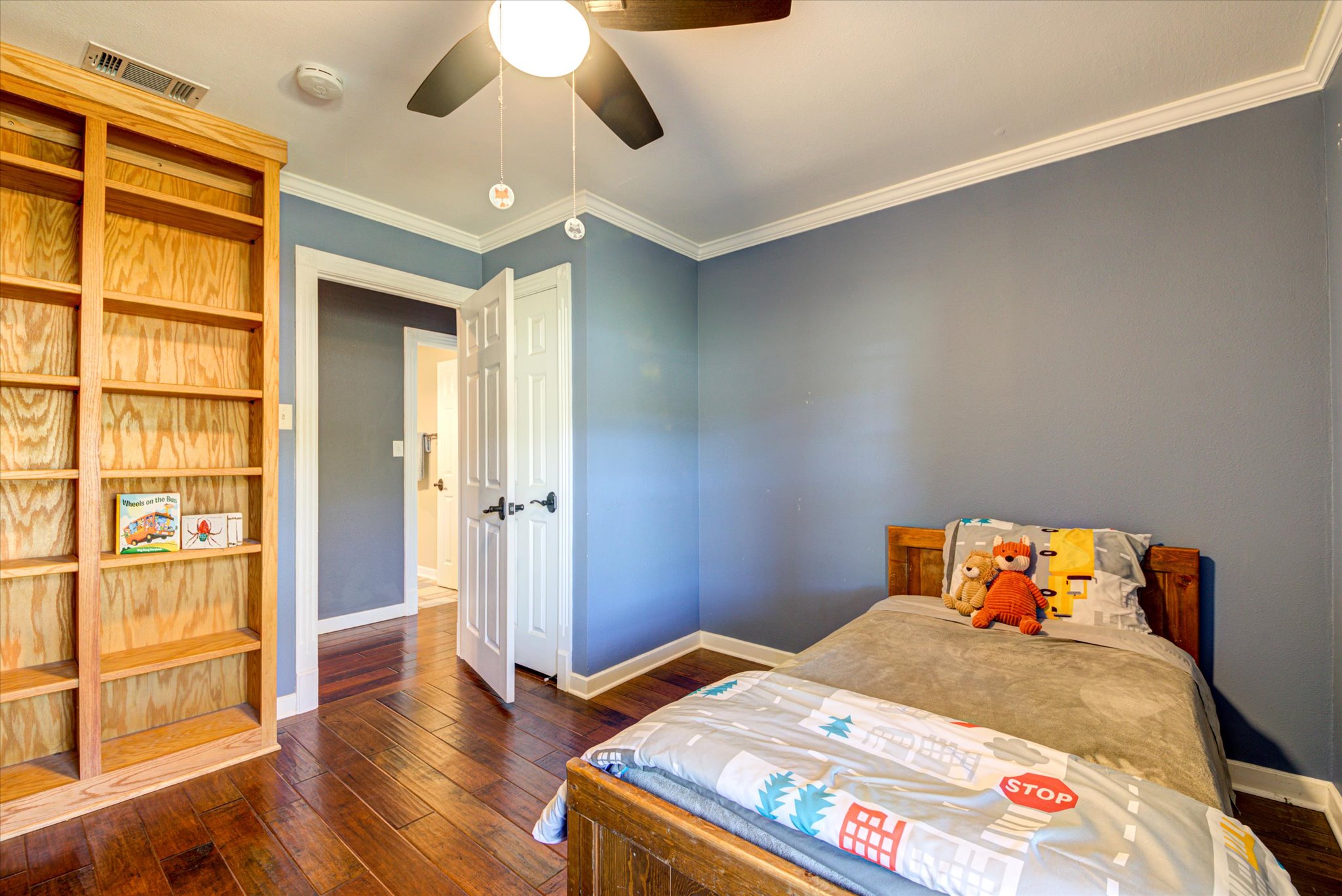 13423 Trail Driver Street Austin, TX 78737 - Photo 18 of 40 a bedroom with a bed and wooden floor