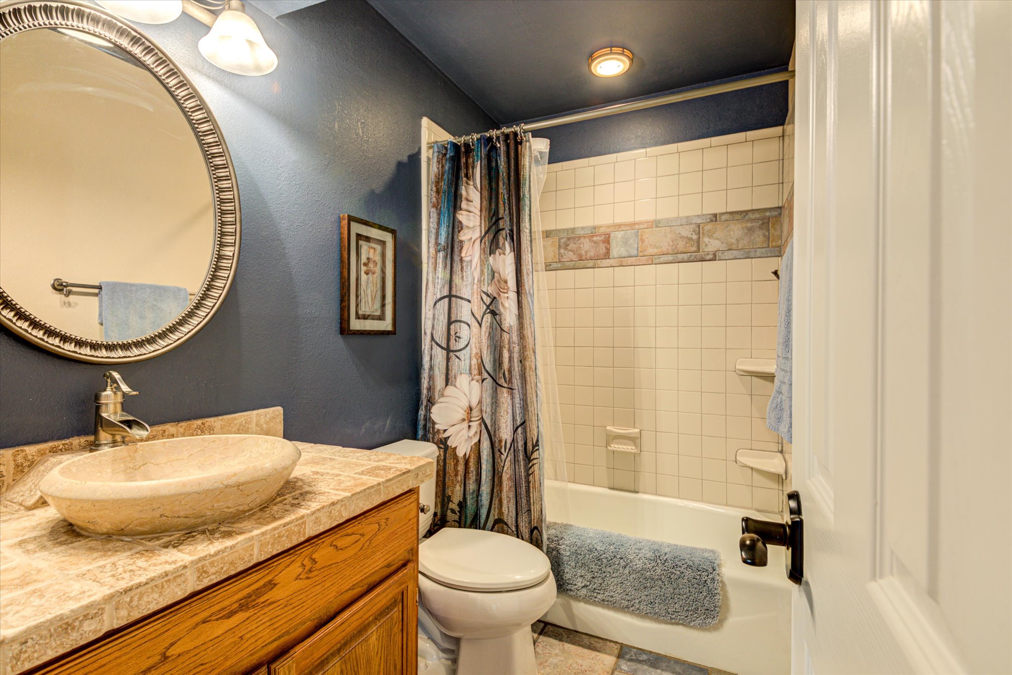 13423 Trail Driver Street Austin, TX 78737 - Photo 19 of 40 a bathroom with a granite countertop sink toilet and a mirror