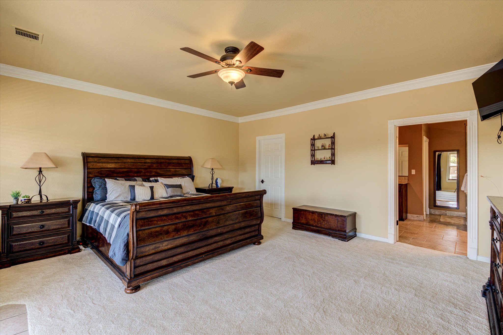 13423 Trail Driver Street Austin, TX 78737 - Photo 23 of 40 a spacious bedroom with a bed and dresser