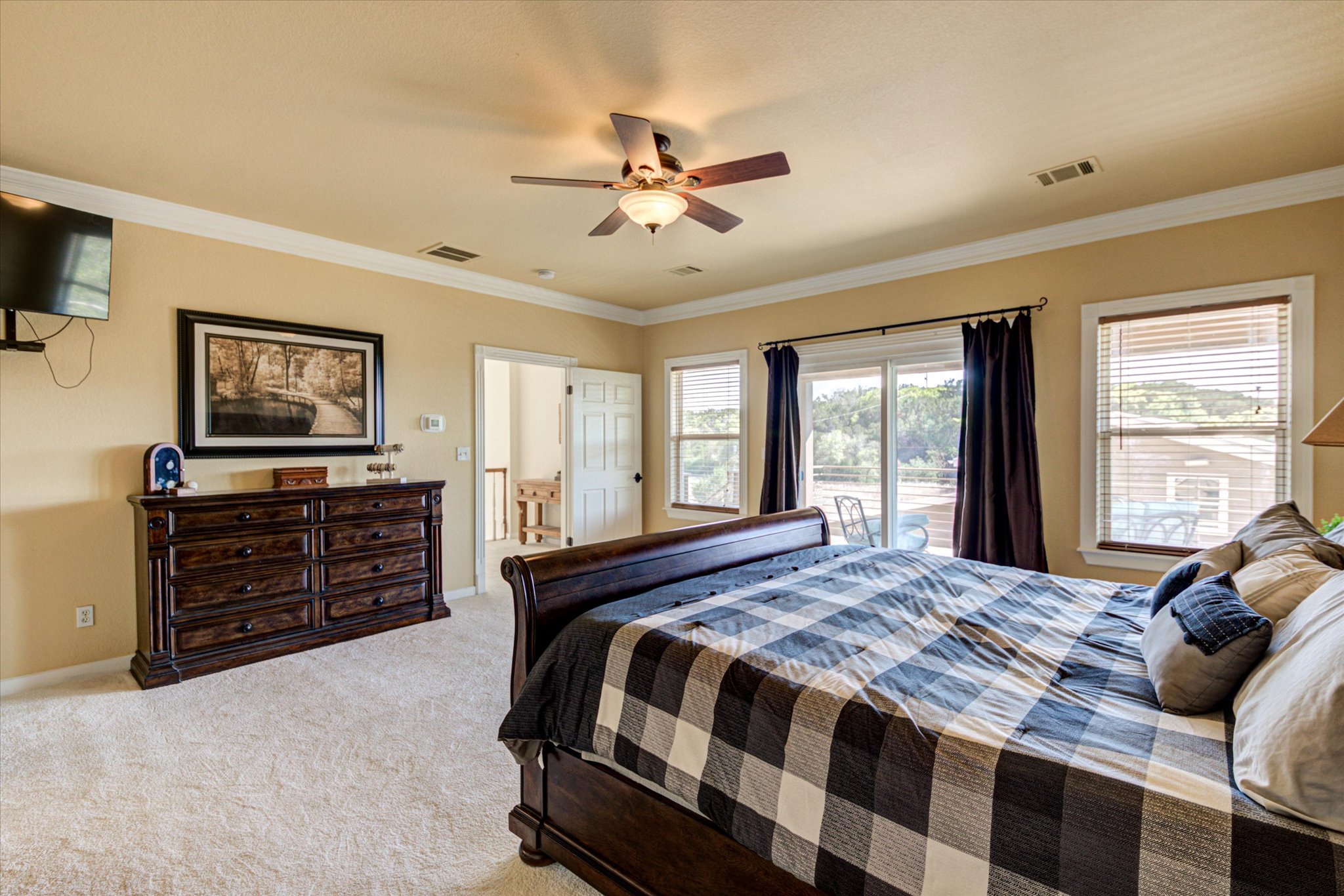 13423 Trail Driver Street Austin, TX 78737 - Photo 24 of 40 a bedroom with a bed and wooden floor