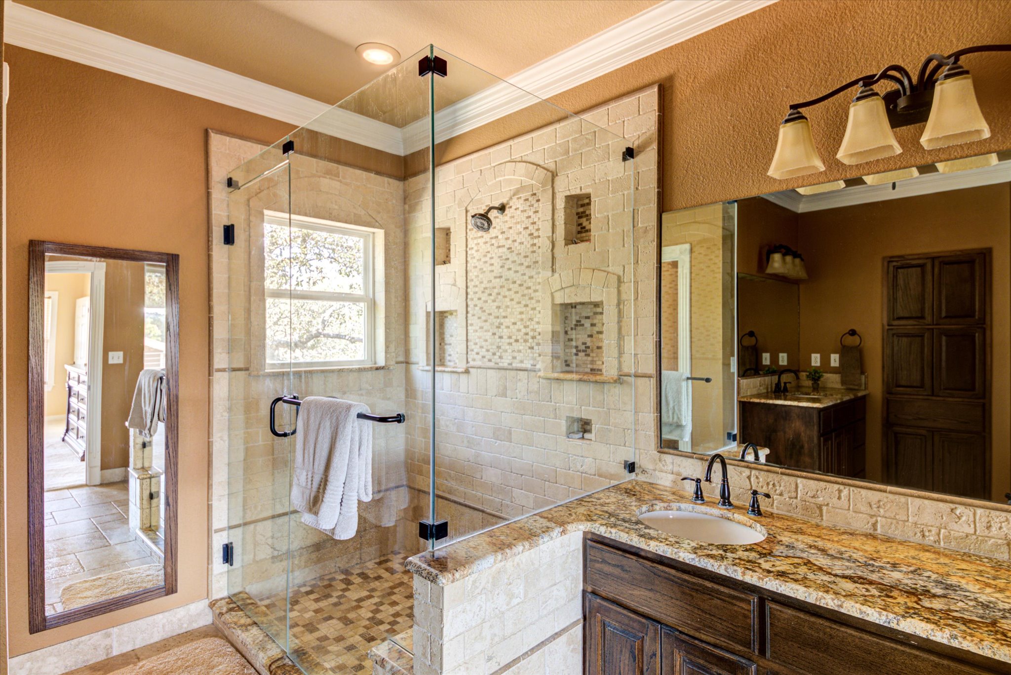 13423 Trail Driver Street Austin, TX 78737 - Photo 27 of 40 a bathroom with a granite countertop sink mirror and a shower