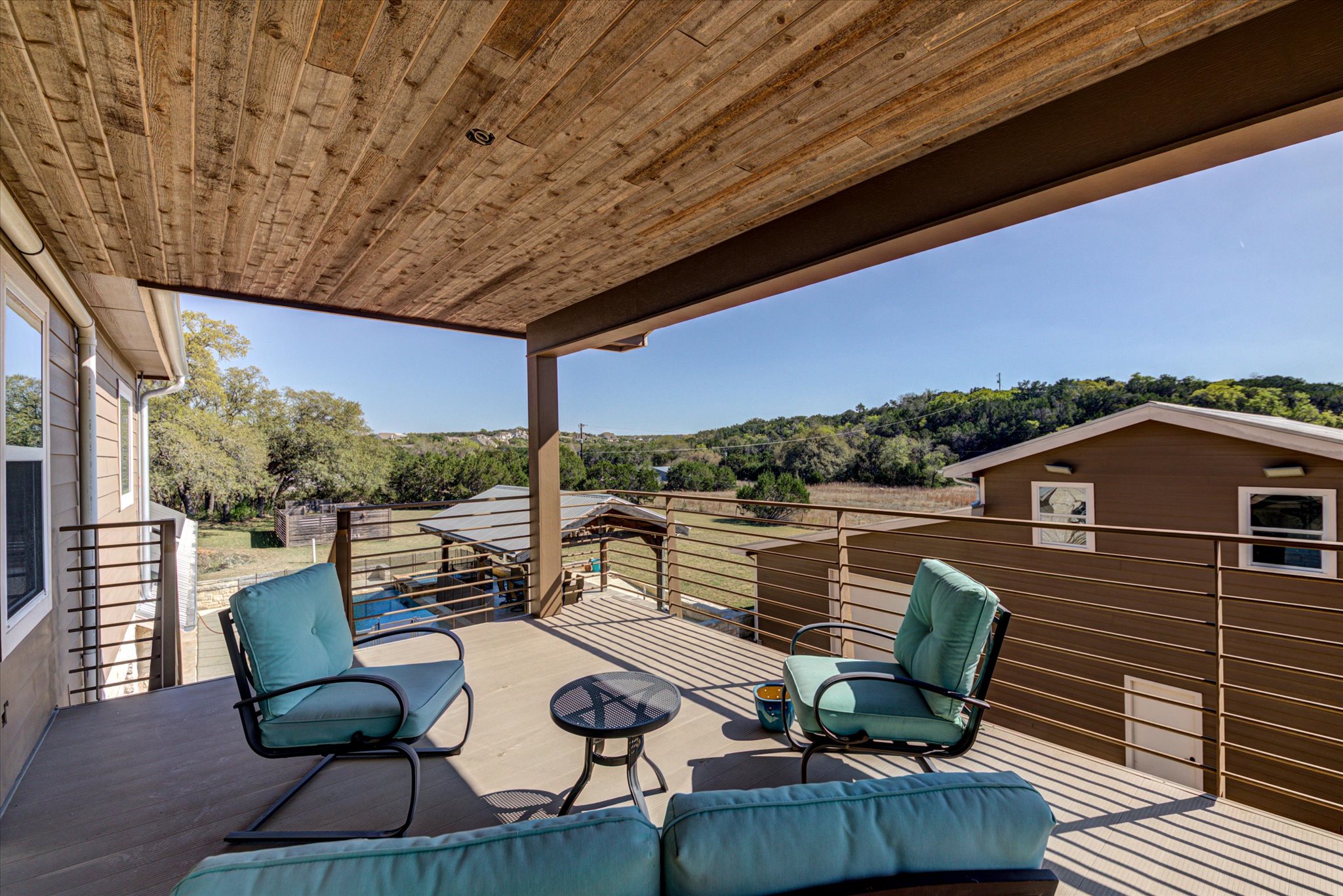 13423 Trail Driver Street Austin, TX 78737 - Photo 28 of 40 a balcony with wooden floor and outdoor seating