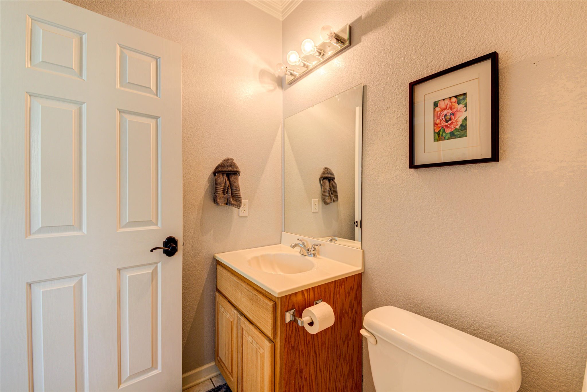 13423 Trail Driver Street Austin, TX 78737 - Photo 30 of 40 a bathroom with a toilet a sink and mirror