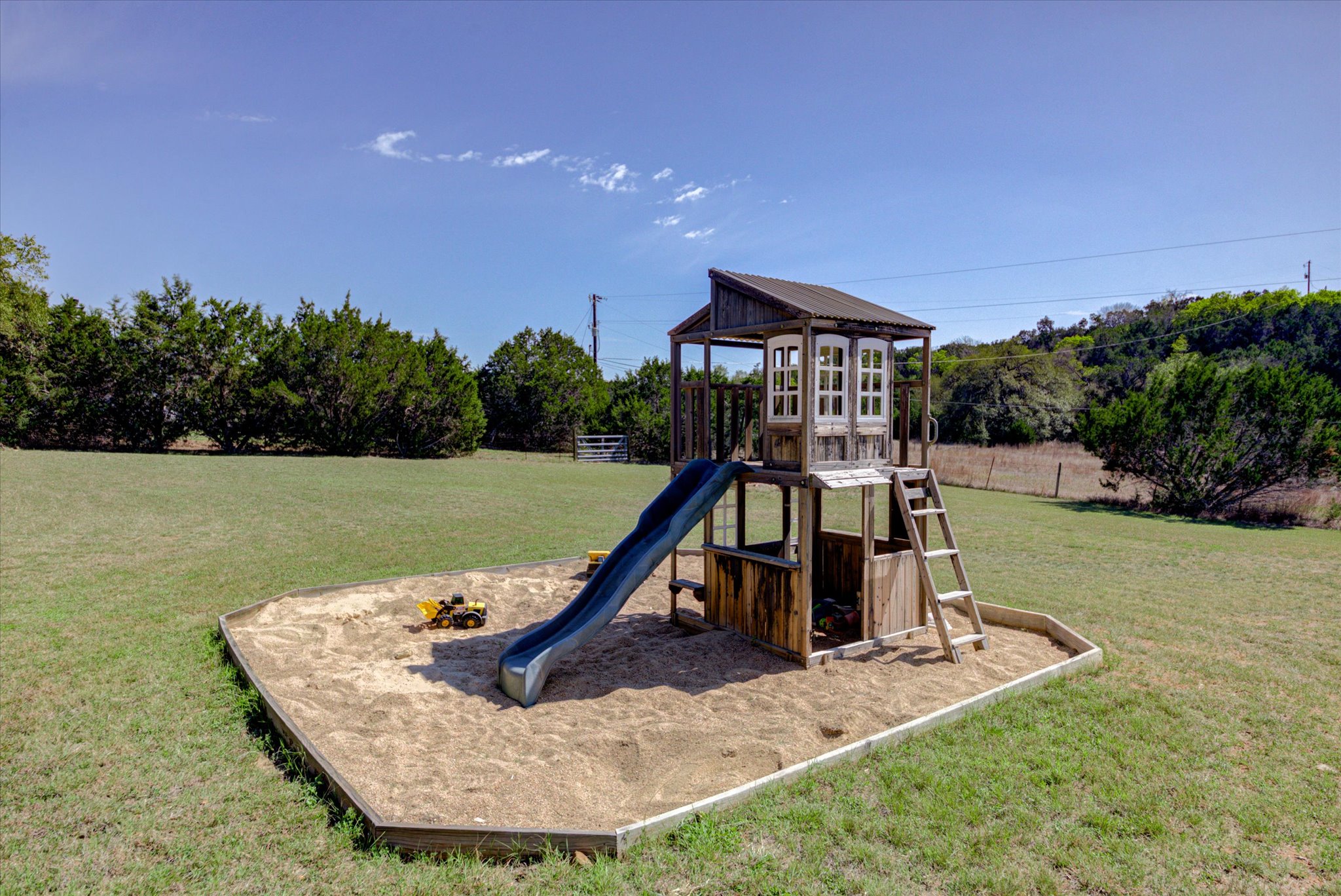 13423 Trail Driver Street Austin, TX 78737 - Photo 35 of 40 a view of a swimming pool with a yard and a wooden fence