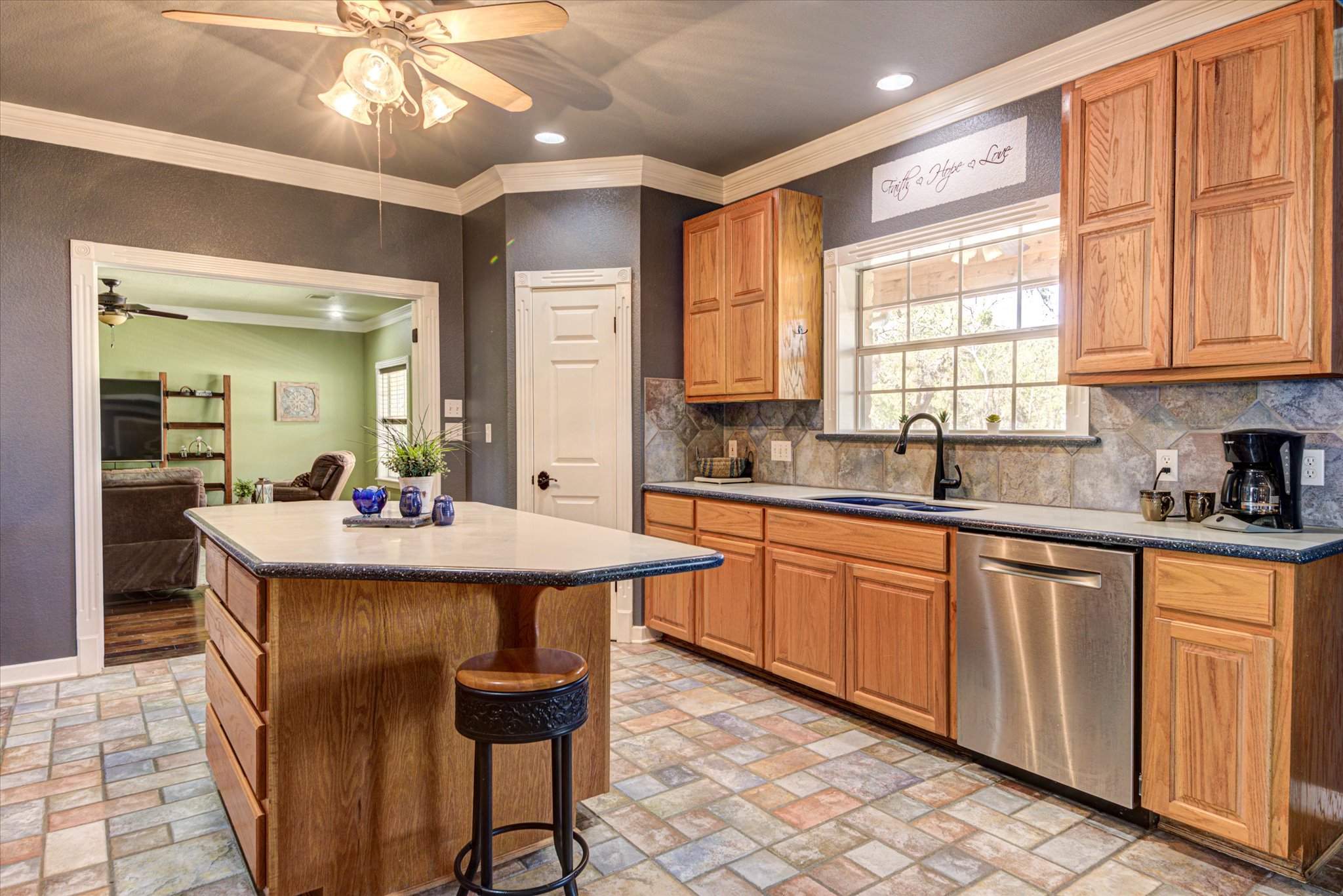 13423 Trail Driver Street Austin, TX 78737 - Photo 9 of 40 a kitchen with sink a window and chairs