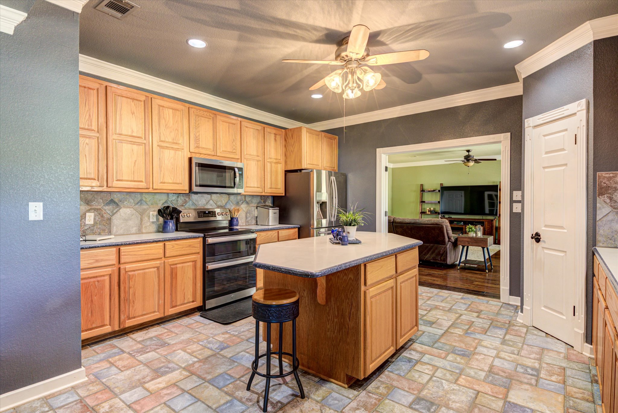 13423 Trail Driver Street Austin, TX 78737 - Photo 10 of 40 a kitchen with a stove a refrigerator and a sink