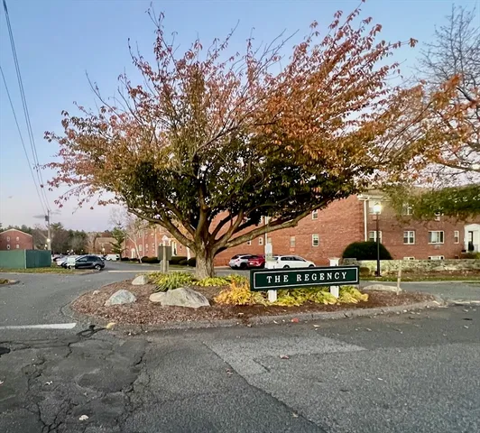 a view of a street with houses and trees