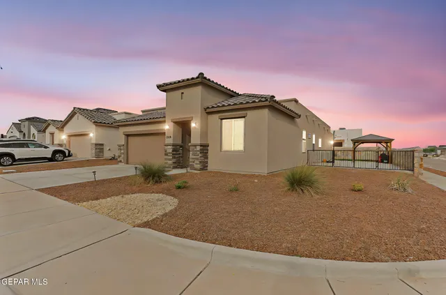 a view of a house with a backyard and a garage