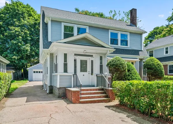 a front view of a house with a garden
