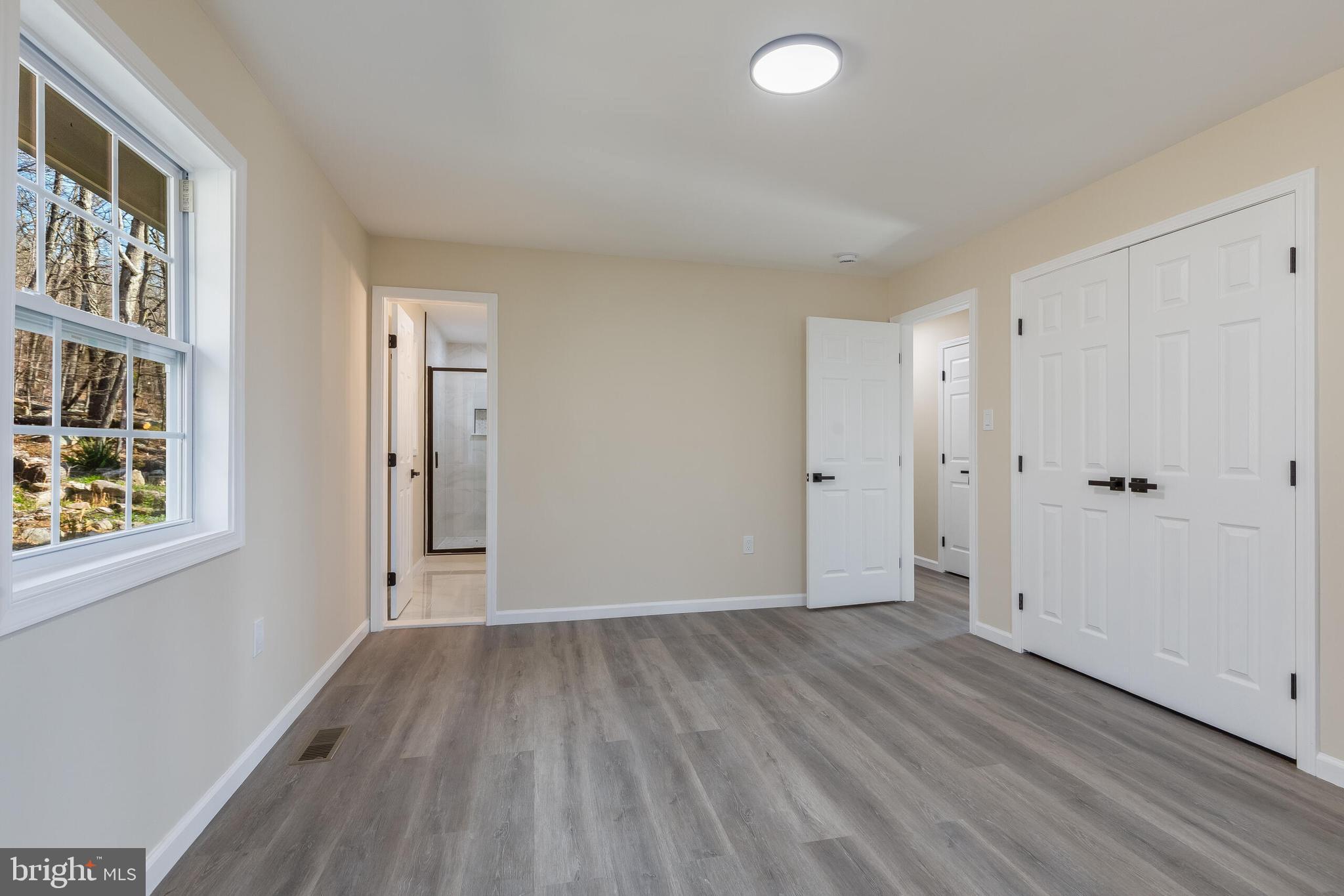 224 Hawk Trail Winchester, VA 22602 - Photo 12 of 29 wooden floor in an empty room with a window
