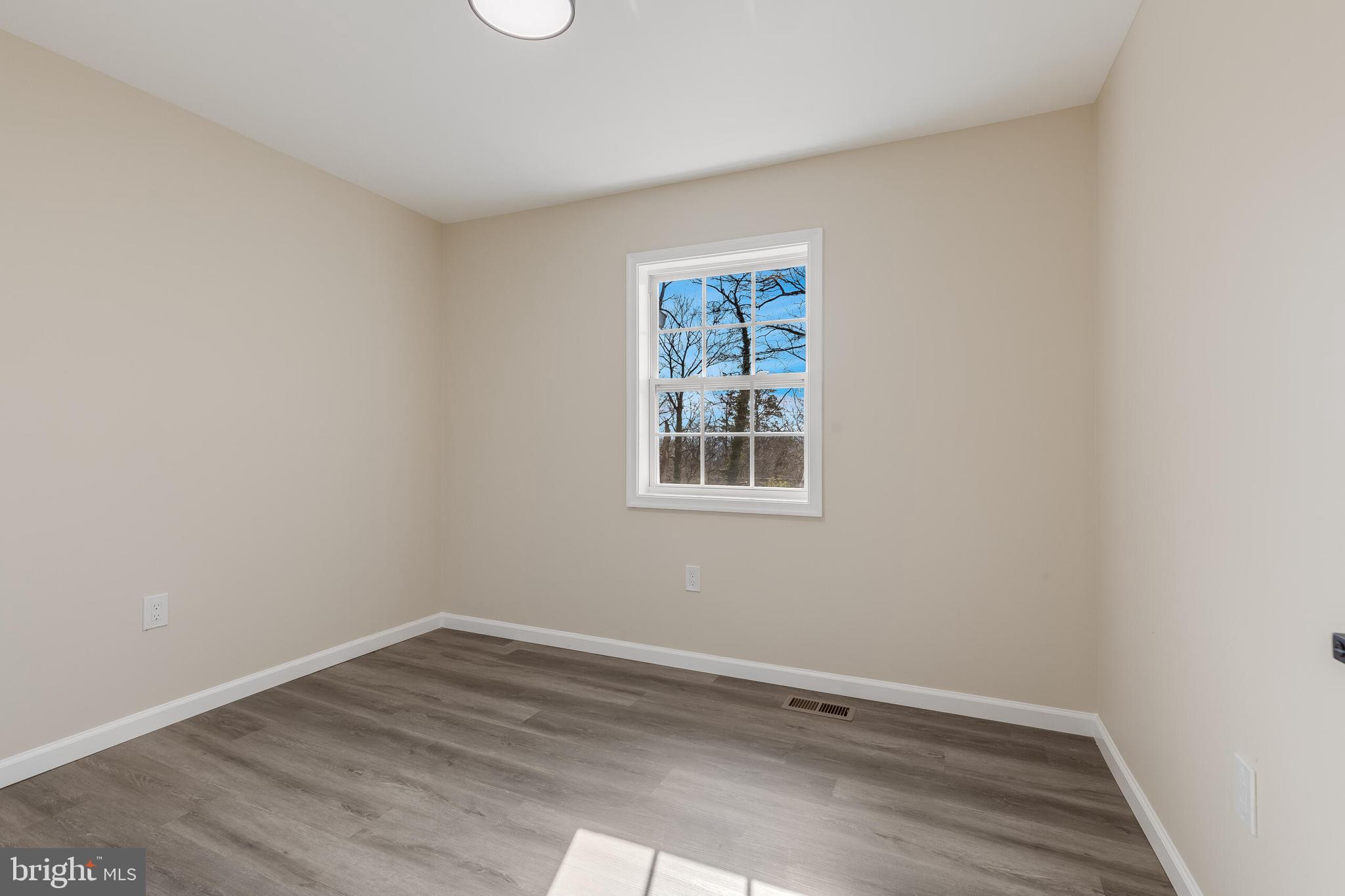 224 Hawk Trail Winchester, VA 22602 - Photo 18 of 29 wooden floor in an empty room with a window