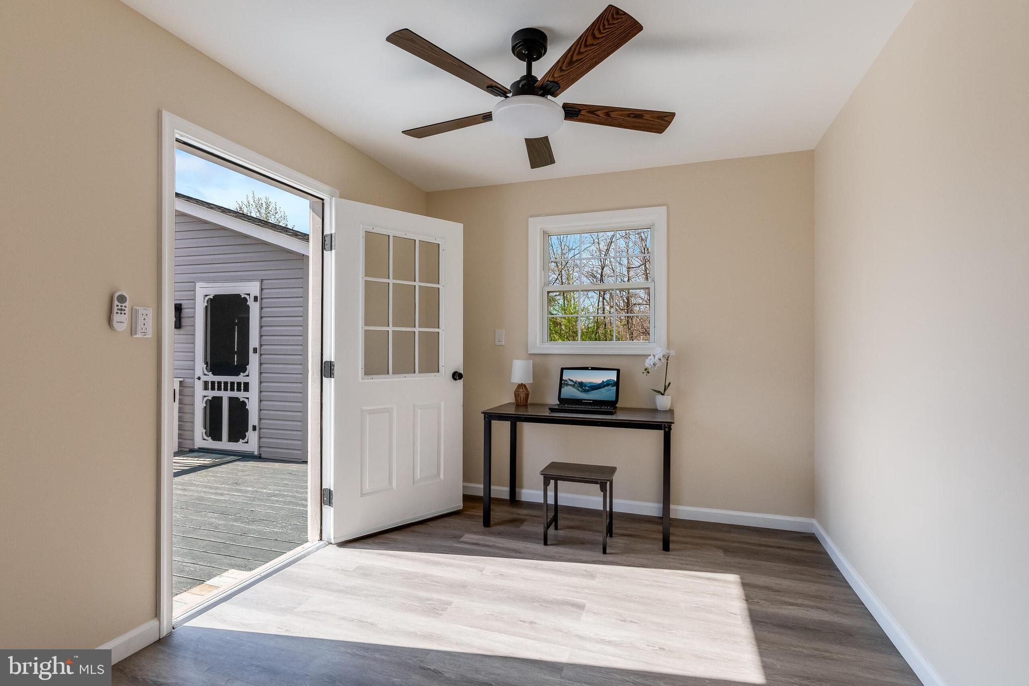 224 Hawk Trail Winchester, VA 22602 - Photo 22 of 29 a workspace room with wooden floor windows and a ceiling fan