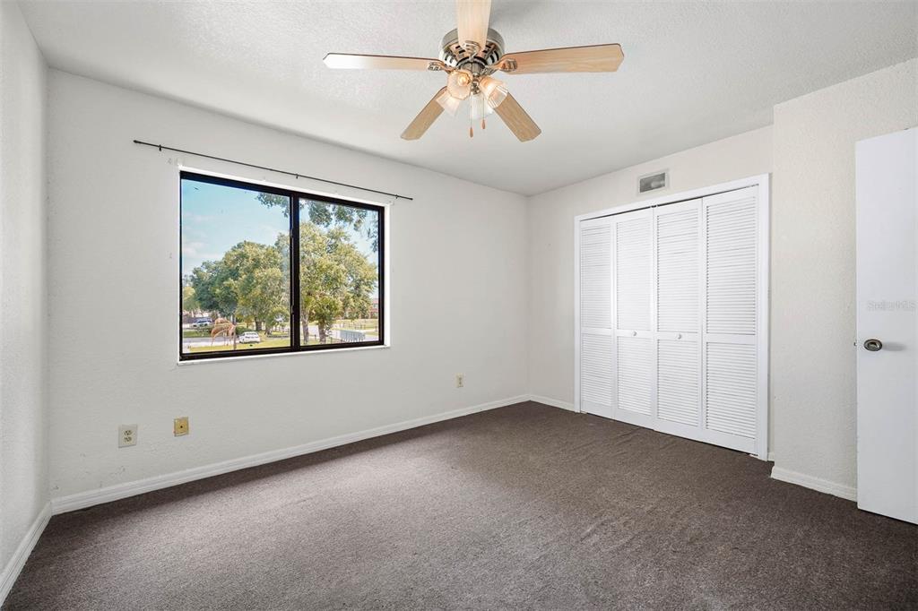12062 Tift Circle Orlando, FL 32826 - Photo 17 of 26 an empty room with windows and fan