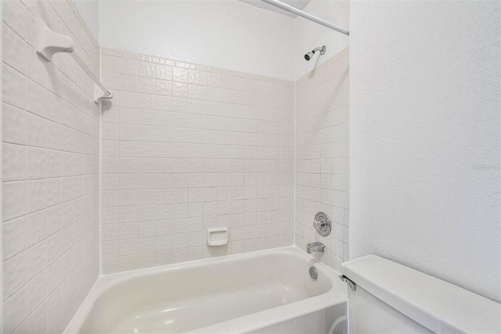 12062 Tift Circle Orlando, FL 32826 - Photo 21 of 26 a bathroom with a bathtub and shower