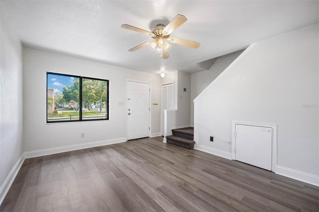 12062 Tift Circle Orlando, FL 32826 - Photo 3 of 26 wooden floor in an empty room with a window