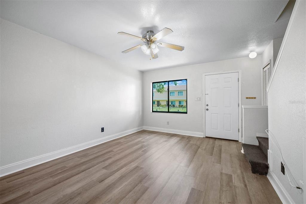 12062 Tift Circle Orlando, FL 32826 - Photo 4 of 26 wooden floor in an empty room with a window