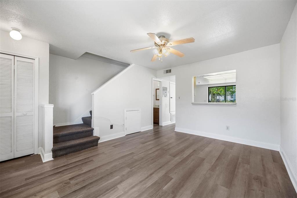 12062 Tift Circle Orlando, FL 32826 - Photo 5 of 26 a view of an empty room with wooden floor and a window