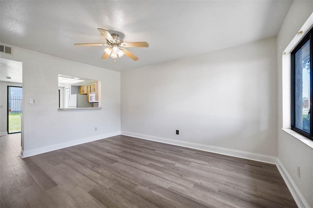 12062 Tift Circle Orlando, FL 32826 - Photo 6 of 26 wooden floor in an empty room with a window