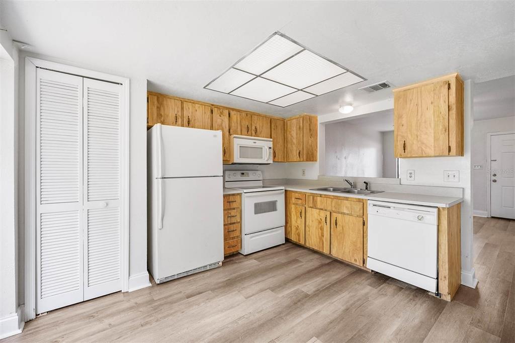12062 Tift Circle Orlando, FL 32826 - Photo 7 of 26 a kitchen with a refrigerator a sink and cabinets