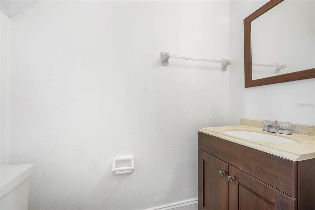 12062 Tift Circle Orlando, FL 32826 - Photo 10 of 26 a bathroom with a sink a vanity and a mirror