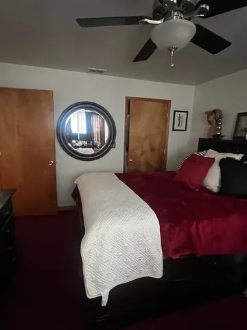 a bedroom with a bed and a chandelier