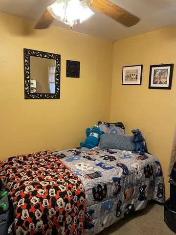 a bedroom with a bed and a painting on the wall