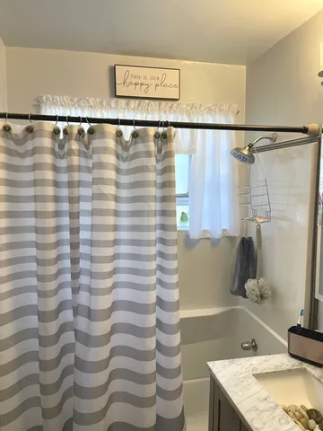 a bathroom with a shower and a sink