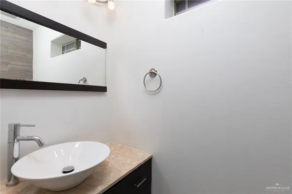 a bathroom with a sink and mirror