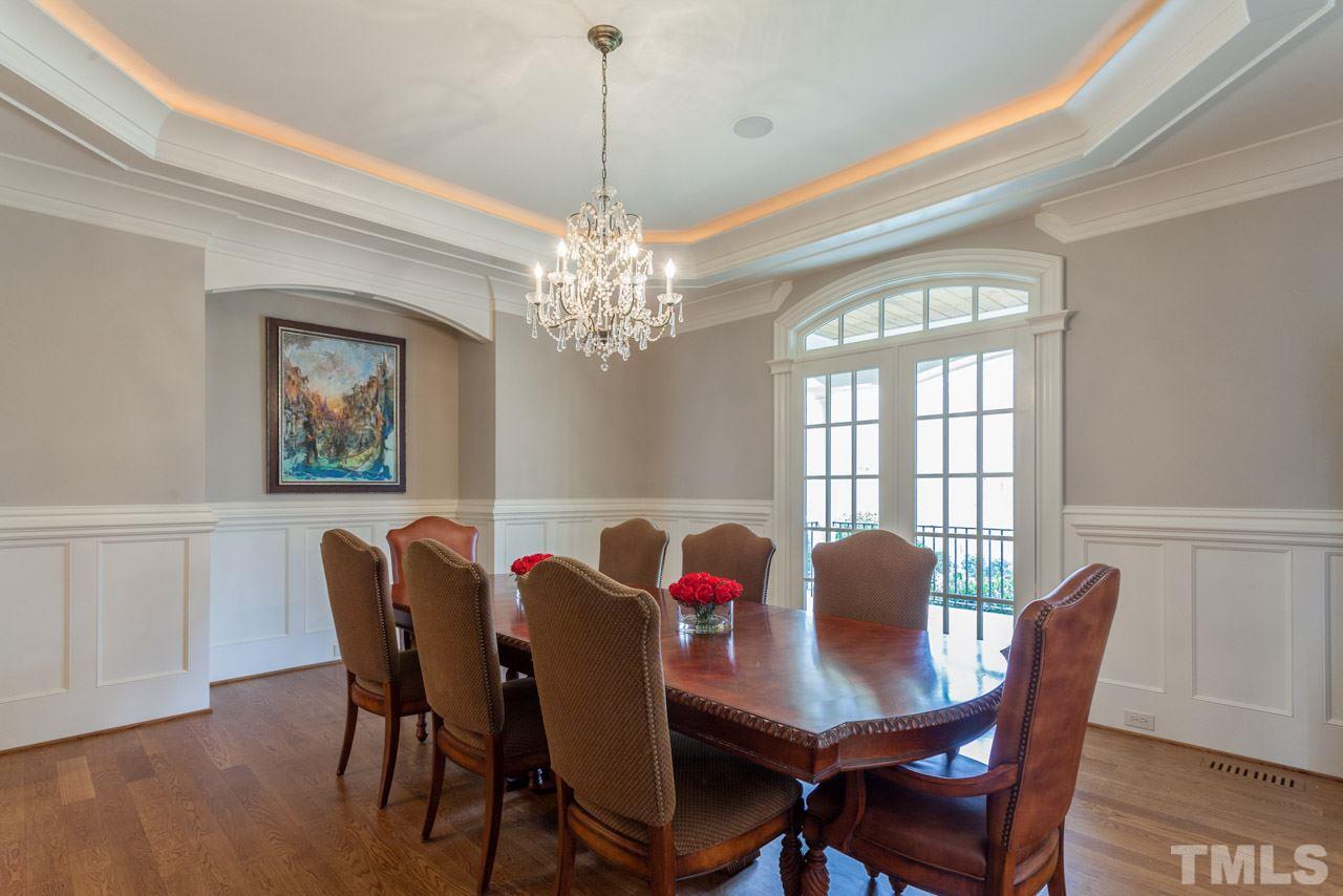 3032 Cone Manor Lane Raleigh, NC 27613 - Photo 12 of 30 a view of a dining room with furniture a chandelier and wooden floor
