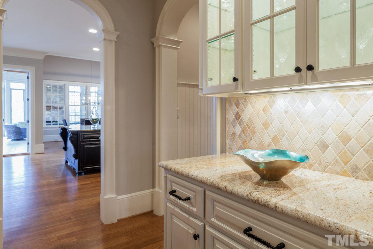 3032 Cone Manor Lane Raleigh, NC 27613 - Photo 13 of 30 a kitchen with granite countertop white cabinets and wooden floor