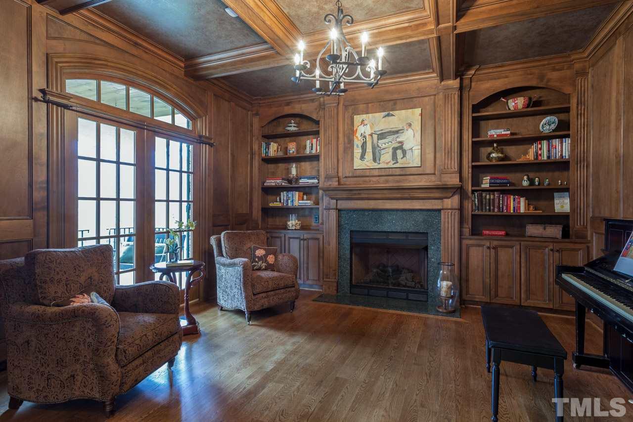 3032 Cone Manor Lane Raleigh, NC 27613 - Photo 14 of 30 a living room with furniture a chandelier and a fireplace