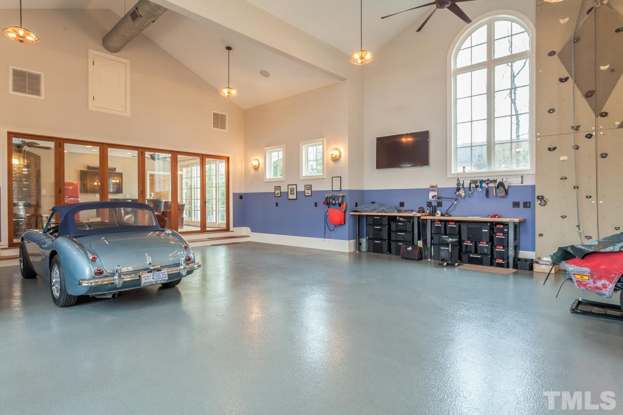 3032 Cone Manor Lane Raleigh, NC 27613 - Photo 26 of 30 a living room with lots of furniture and gym equipment