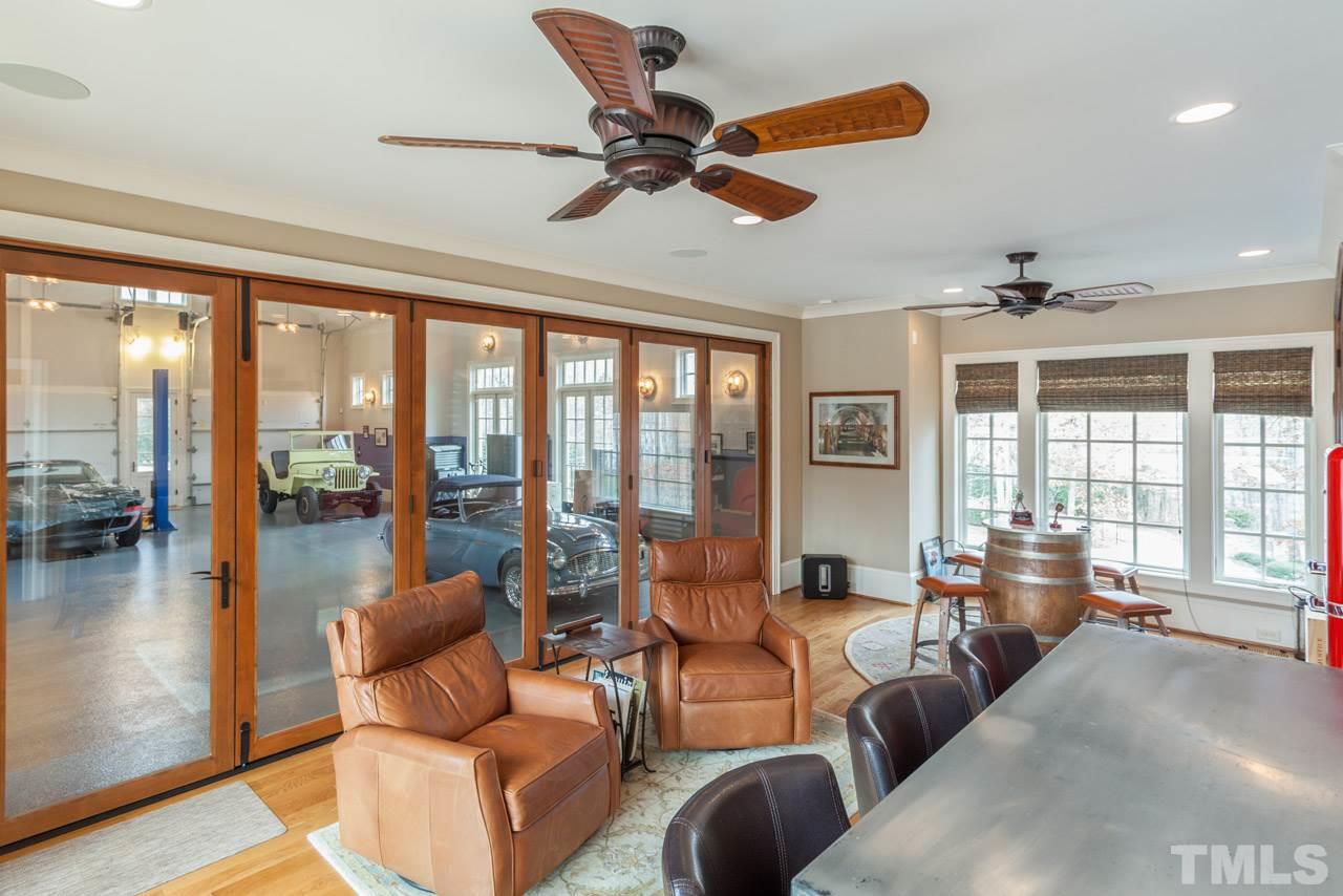 3032 Cone Manor Lane Raleigh, NC 27613 - Photo 27 of 30 a living room with furniture and floor to ceiling windows