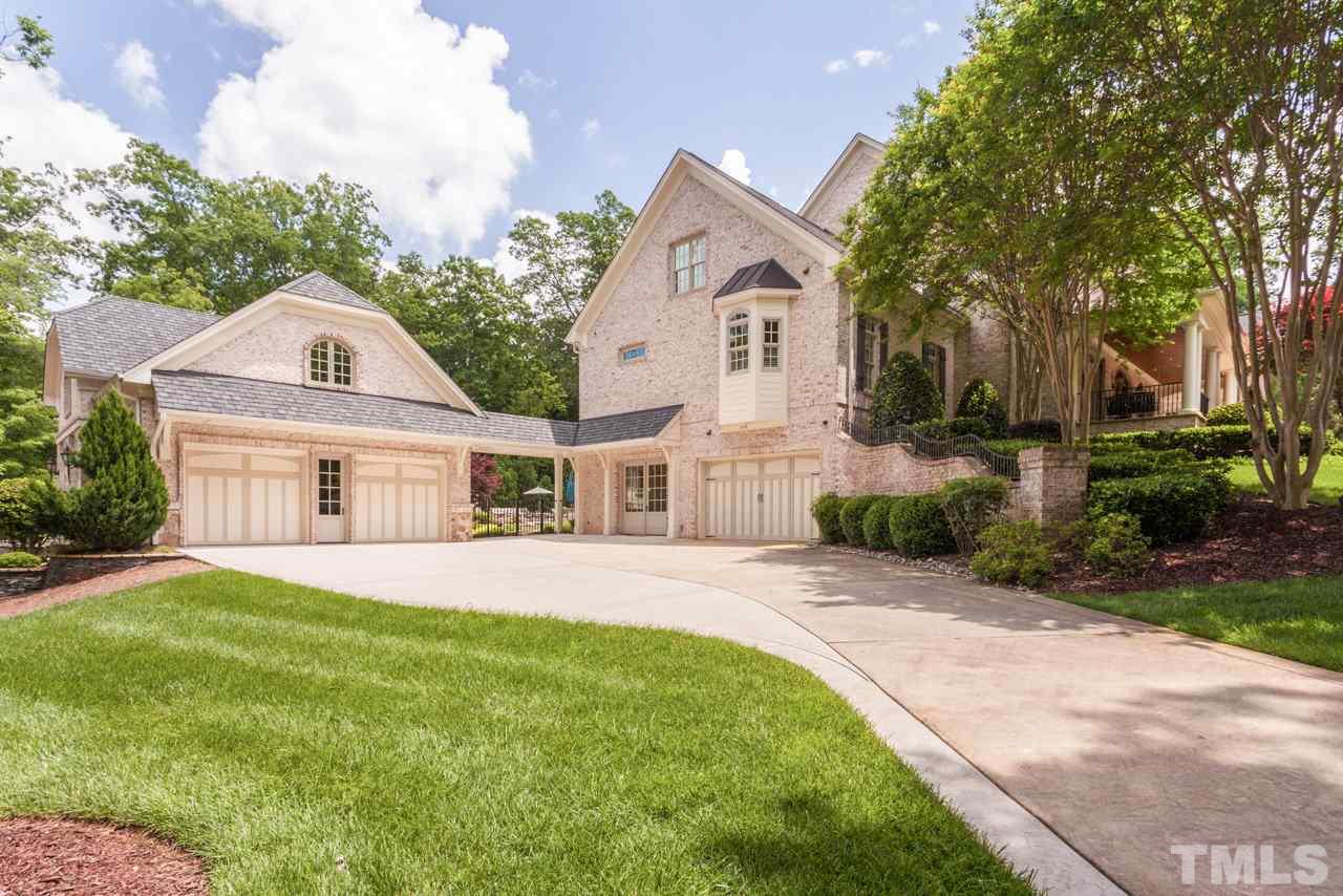 3032 Cone Manor Lane Raleigh, NC 27613 - Photo 29 of 30 a front view of a house with a garden and trees