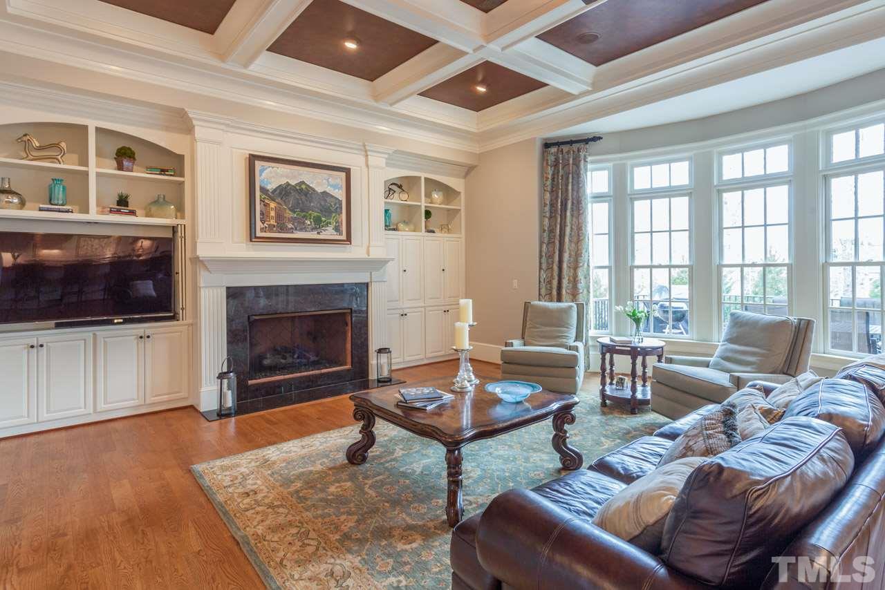 3032 Cone Manor Lane Raleigh, NC 27613 - Photo 5 of 30 a living room with furniture a flat screen tv and a fireplace