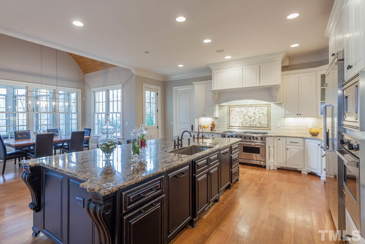 3032 Cone Manor Lane Raleigh, NC 27613 - Photo 8 of 30 a large kitchen with lots of counter space and stainless steel appliances