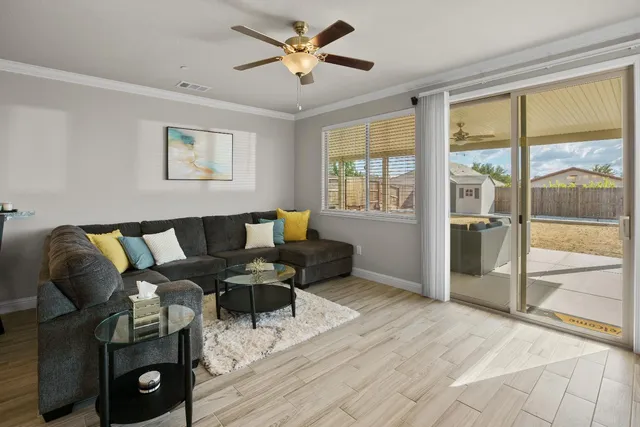 a living room with furniture and a floor to ceiling window