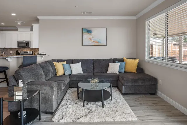 a living room with furniture and a large mirror