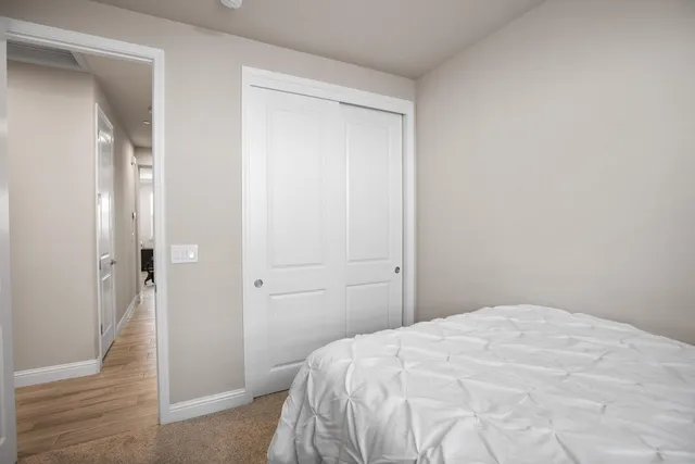 a bedroom with a bed and a view of bathroom