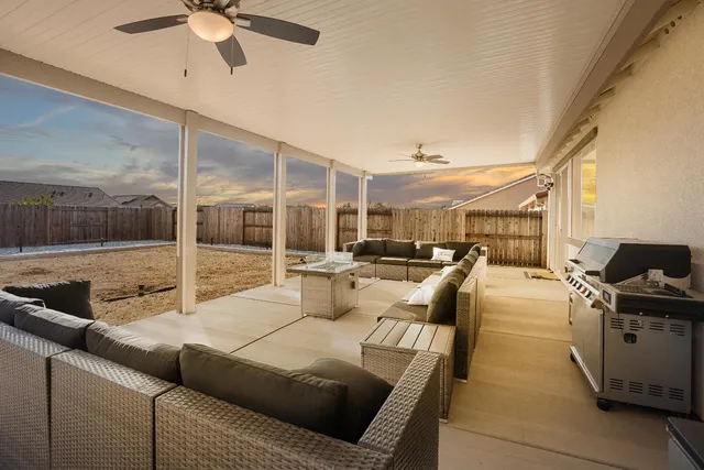 a dining room with furniture and a floor to ceiling window