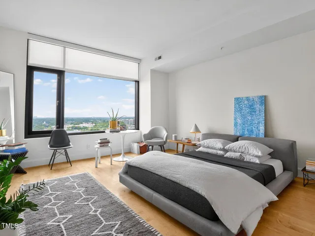 a bedroom with two beds and large window