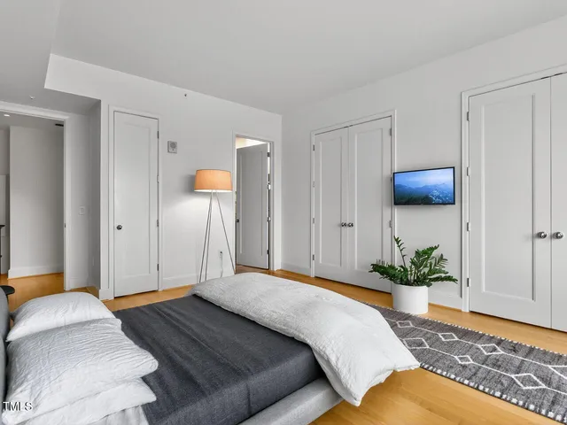 a bedroom with a bed and a painting on the wall