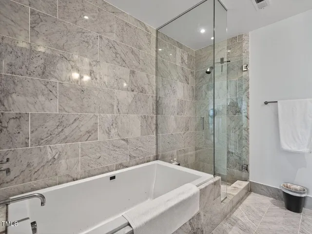 a bathroom with a bathtub and a shower