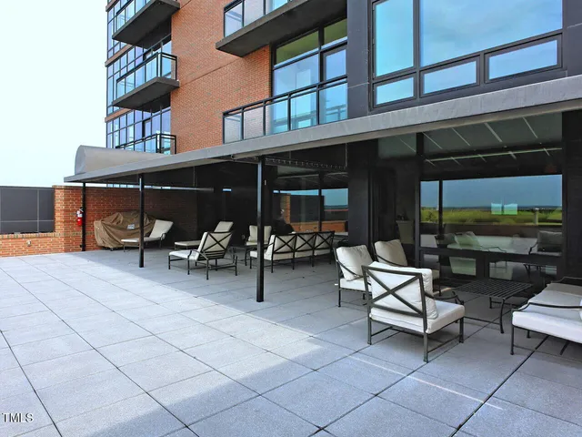 a view of a patio with a table and chairs