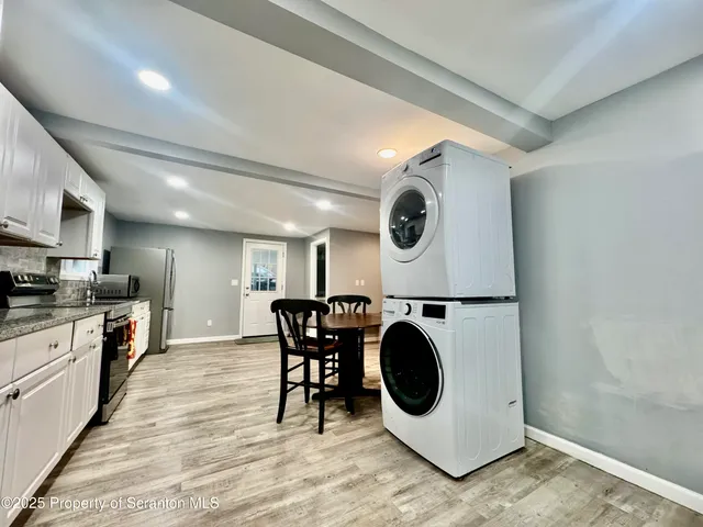 a kitchen with a stove a microwave and a dining table