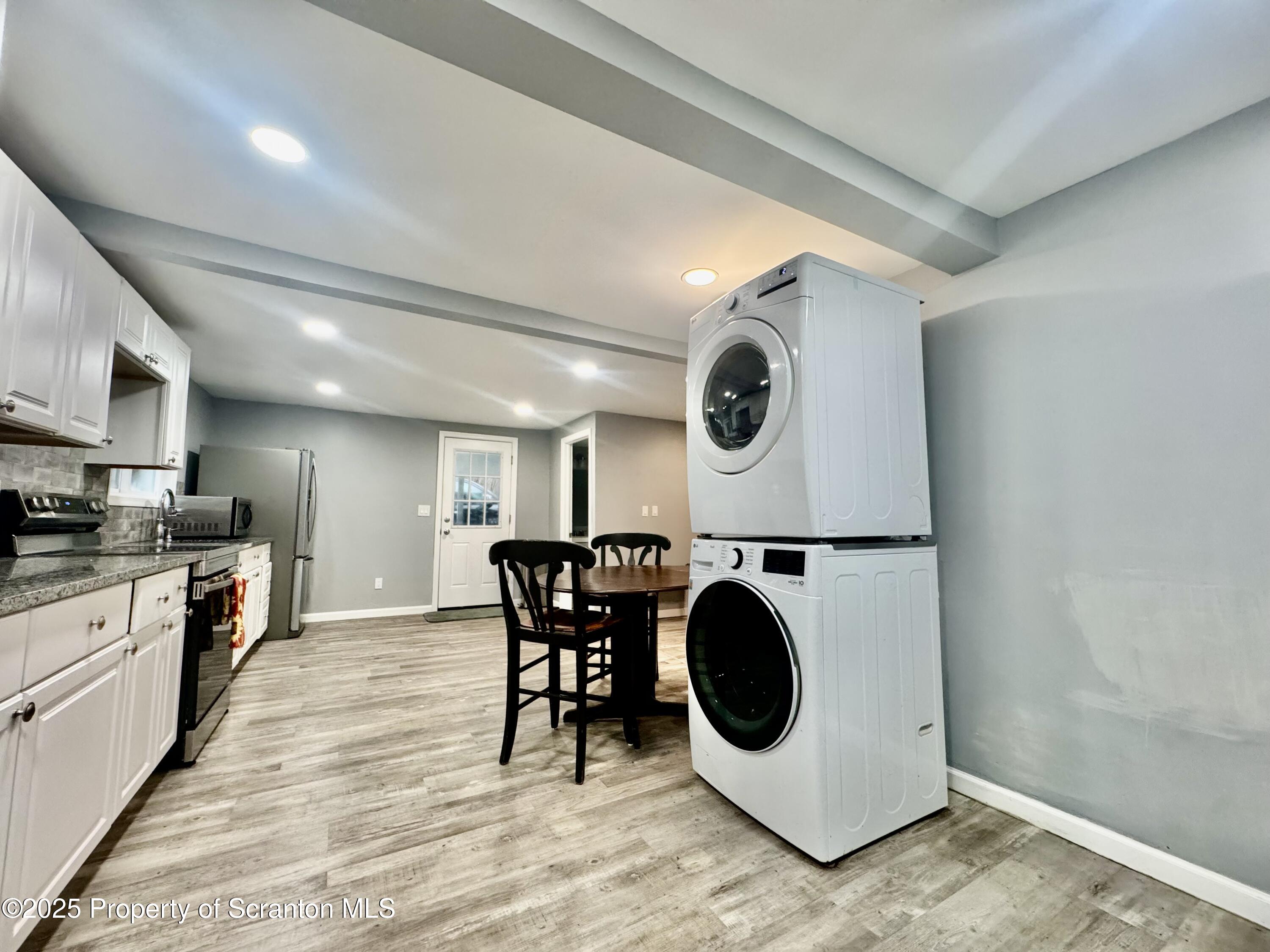 4 Maple Street Pittston, PA 18640 - Photo 12 of 25 a kitchen with a stove a microwave and a dining table